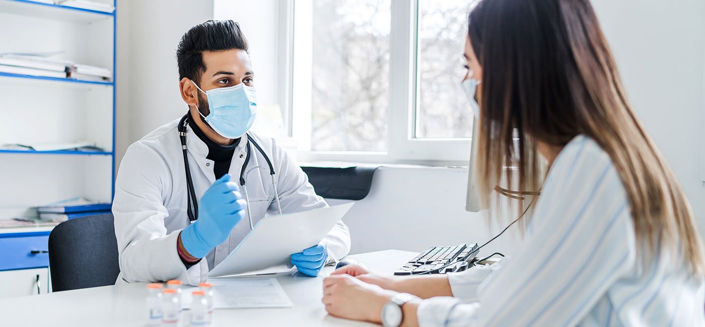 A doctor speaks with a patient in an ENT clinic in Dubai, discussing health concerns and treatment options.